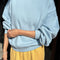 model wearing light blue relaxed fit sweatshirt