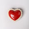 top view of ceramic heart shaped trinket box with white scalloped trim and cursive 'everything' in the inside