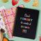 black mini notebook with colorful and white 'Don't FORGET to write it DOWN!!!!' typography across the front and pink notebook