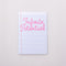 white notebook with lined paper with pink 'infinite potential' across the front