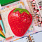 realistic strawberry notepad on desk items
