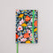 black 12-month classic planner with green elastic closure and bookmark with all over colorful floral print