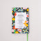 back view of black 12-month classic planner with green elastic closure and bookmark with all over colorful floral print