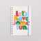 cream medium annual soft cover 12-month planner with colorful block lettered 'let's have some fun.' typography with light blue elastic closure