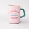 light pink ceramic mug with teal handle and 'do not disturb! i am currently reading a really good book!' typography on both sides