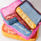 up close of set of 4 colorful packing cubes