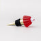 side view of gold brass wine stopper with red jello mold topper and black rubber stopper