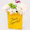 yellow pasta box ceramic vase that says 'BUON APPETITO' with flowers inside