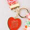 up close of red heart keychain that says 'good things' ahead