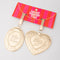 Side view of set of two gold metallic locket luggage tags