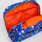 interior of cobalt blue toiletry bag with red bow handle and colorful folk floral print