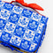 up close of blue and white Scandinavian plaid with red bow handle