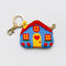 blue house bag charm with red and yellow trim