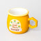 side view of gold yellow mug that says 'locally sources wild flower honey' with honeycomb shaped handle