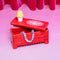 red dress trinket box with yellow lamp and cat doily