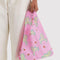 model holding pink baby baggu with all over lamb print