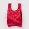 red baby baggu with bright red polka dots
