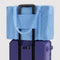 sky blue cloud carry on bag on a purple suitcase