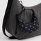 black crescent bag charm with sky blue micro dots on a purse