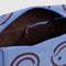 brown interior of sky blue dopp kit with brown smiley print