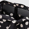 interior of black everyday cloud bag with white polka dots