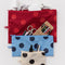 set of 3 polka dot go pouch set: cream with black dots, blue with dark blue dots and red with bright red dots with items inside