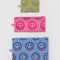 set of 3 flat pouch set: small yellow with periwinkle smiley, medium hot pink with bright smiley, and large light blue with brown smiley