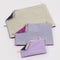 flattened set of three go pouch set: small lavender/deep sea, medium light blue/fuchsia pink, and large plum/pale yellow