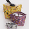 set of 3 wildwood go pouch set: grey floral, plum floral, and yellow floral with items inside