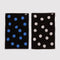 reversed set of two polka dot hand towels: blue with black dots, and cream with black polka dots