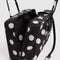 key leash of black medium bowler bag with cream polka dot print