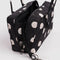 interior key leash of black nylon bowler bag with cream polka dots