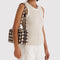 model carrying brown blurred gingham nylon bowler bag