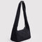 side view of black meringue bag with thick twist strap