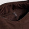 interior pocket of dark brown meringue bag with thick twist strap