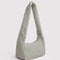 sideview of green and white vertical stripe meringue bag with thick twist strap