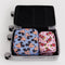 set of two packing cube set with small pink minnie and medium periwinkle mickey head in a suitcase