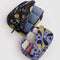 set of 2 packing cubes: small periwinkle with golden pears and medium black winter gourd with items inside