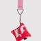 red puffy earbud case with lamb print hanging from a lanyard