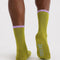 back view of olive green socks with lavender and light green trim