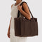 model carrying coffee small cloud carry on bag
