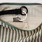 black interior key leash of sage and white vertical stripe small crescent bag