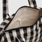 cream interior of black and white gingham small duffle bag