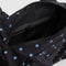 black interior of black small duffle bag with sky blue micro dot print