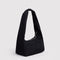 side view of black small meringue bag with thick twist strap
