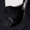 interior pocket of black small meringue bag with thick twist strap