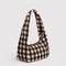 side view of brown blurred gingham small meringue bag with thick twist strap