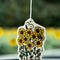 snoopy on his doghouse with yellow flower field around it air freshener hanging from a mirror
