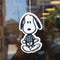 snoopy skeleton air freshener hanging in front of a window