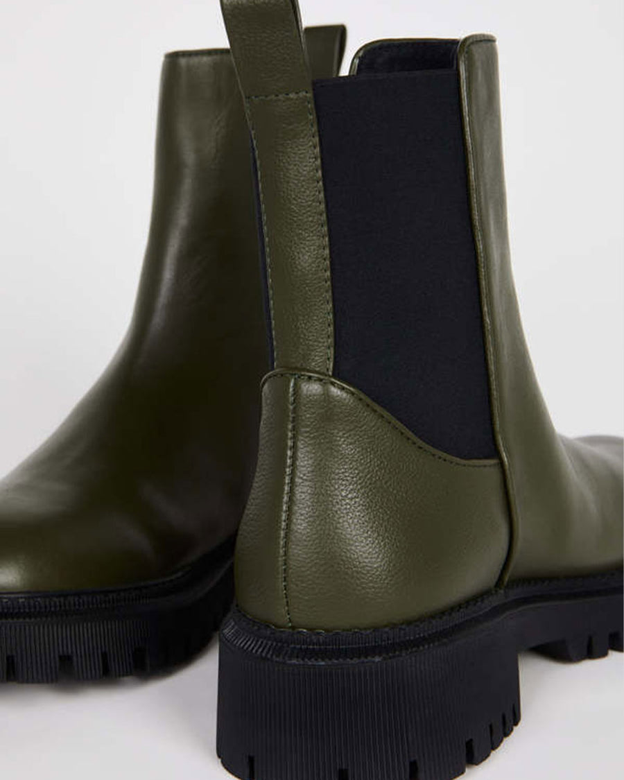 up close of black elastic on hunter green chunky sole boots